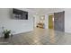 Bright living room featuring tile flooring, a large mounted television, and contemporary decor at 9410 N 4Th Ave, Phoenix, AZ 85021