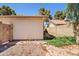 Backyard featuring a gate, a retaining wall, and vegetation at 955 E Vaughn Ave, Gilbert, AZ 85234