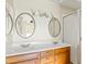 Bathroom featuring a double sink vanity, framed mirrors, and a walk-in shower at 955 E Vaughn Ave, Gilbert, AZ 85234