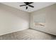 Empty bedroom with carpet floors, a window with blinds, and bright walls at 955 E Vaughn Ave, Gilbert, AZ 85234
