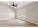 A spacious bedroom with vaulted ceilings, fan and fixture, and oversized window at 955 E Vaughn Ave, Gilbert, AZ 85234