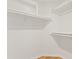 A walk-in closet with custom shelving and hardwood floors at 955 E Vaughn Ave, Gilbert, AZ 85234