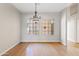 Well-lit dining room offers a charming chandelier and natural light at 955 E Vaughn Ave, Gilbert, AZ 85234
