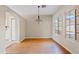Dining room with hardwood floors and stylish chandelier, next to kitchen at 955 E Vaughn Ave, Gilbert, AZ 85234
