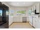 The remodeled kitchen is equipped with stainless steel appliances, quartz counters and light wood floors at 955 E Vaughn Ave, Gilbert, AZ 85234