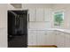 This kitchen boasts white cabinets, stone countertops, and stainless steel appliances at 955 E Vaughn Ave, Gilbert, AZ 85234