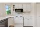 Updated kitchen features white cabinets and countertops, stainless steel appliances, and natural lighting at 955 E Vaughn Ave, Gilbert, AZ 85234