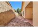 Exterior shot of a side yard featuring rock groundcover and a brick wall at 955 E Vaughn Ave, Gilbert, AZ 85234