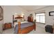 Bedroom with wooden bed frame, nightstands, and large window at 9707 E Mountain View Rd # 2430, Scottsdale, AZ 85258