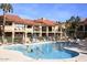 Inviting community pool with residents enjoying a sunny day at 9707 E Mountain View Rd # 2430, Scottsdale, AZ 85258