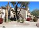 Exterior view of condo building with landscaping and walkway at 9707 E Mountain View Rd # 2430, Scottsdale, AZ 85258