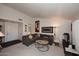 Living room with gray sectional sofa, coffee table, and large artwork at 9707 E Mountain View Rd # 2430, Scottsdale, AZ 85258