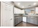 Well-lit kitchen featuring two-tone cabinets and a stylish backsplash at 1081 E Lowell Ct, Gilbert, AZ 85295