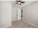 Neutral bedroom with grey walls, light wood floors, ceiling fan and a closet with white paneled door at 124 E Beech Ave, Casa Grande, AZ 85122