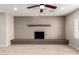 Living room features a gray brick fireplace, sleek flooring, and recessed lighting at 124 E Beech Ave, Casa Grande, AZ 85122