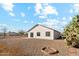 A neutral desert landscape backyard has a patio and views of neighboring houses at 12459 W Benito Dr, Arizona City, AZ 85123