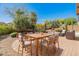 Outdoor patio seating area surrounded by mature landscaping and desert views at 12541 W Miner Trl, Peoria, AZ 85383