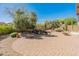 Backyard features a stone fountain, paver patio, desert landscaping, and mountain views at 12541 W Miner Trl, Peoria, AZ 85383