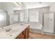 Bathroom featuring double sinks, a soaking tub, and a separate glass-enclosed shower at 12541 W Miner Trl, Peoria, AZ 85383