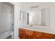 Well-lit bathroom with a shower-tub combination and wood cabinets at 12541 W Miner Trl, Peoria, AZ 85383