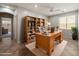 Dedicated home office with custom wood desk, shelves, and lots of natural light at 12541 W Miner Trl, Peoria, AZ 85383