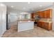 Open kitchen with a center island and modern appliances, seamlessly flowing into the living area at 12541 W Miner Trl, Peoria, AZ 85383