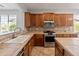 Functional kitchen featuring updated appliances and tile countertops at 12541 W Miner Trl, Peoria, AZ 85383