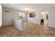 Open-concept living room with tile flooring and an archway to the kitchen at 12541 W Miner Trl, Peoria, AZ 85383