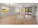 Bright living room with tile floors, large windows, and sliding glass doors leading to the backyard at 12541 W Miner Trl, Peoria, AZ 85383