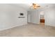Carpeted main bedroom with a ceiling fan, television mount, and bathroom access at 12541 W Miner Trl, Peoria, AZ 85383