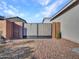 Private backyard gate enclosed by brick pillars and gravel landscaping at 12576 W Oyer Ln, Peoria, AZ 85383