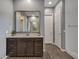 Bathroom featuring wood-look floors, a dark vanity, large mirror, and glass enclosed shower at 12576 W Oyer Ln, Peoria, AZ 85383