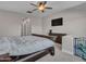 Bedroom featuring a king-size bed, a dresser, neutral-colored walls, and a dog gate in the corner at 12576 W Oyer Ln, Peoria, AZ 85383