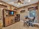 Warm living room boasting brick walls, decorative shelves, and a mounted television at 12576 W Oyer Ln, Peoria, AZ 85383