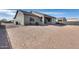 Spacious dirt backyard with a covered patio, providing ample space for custom landscaping and entertainment options at 12700 W Cabrillo Dr, Arizona City, AZ 85123