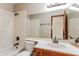 Clean bathroom with a single vanity, shower/tub, and tiled walls at 14237 N Westminster Pl, Fountain Hills, AZ 85268