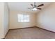 Bright bedroom featuring a ceiling fan and window with natural light at 14237 N Westminster Pl, Fountain Hills, AZ 85268