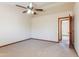 Bedroom with ceiling fan and access to hallway at 14237 N Westminster Pl, Fountain Hills, AZ 85268