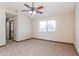 Spacious bedroom with carpeted floor, ceiling fan, and window at 14237 N Westminster Pl, Fountain Hills, AZ 85268