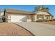Single-story house with a two-car garage and a long driveway at 14237 N Westminster Pl, Fountain Hills, AZ 85268