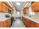 Galley-style kitchen with light wood cabinets and modern appliances at 14237 N Westminster Pl, Fountain Hills, AZ 85268