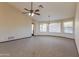 Spacious living room with high ceilings, carpet, and ceiling fans at 14237 N Westminster Pl, Fountain Hills, AZ 85268