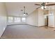 Large living room with high ceilings, neutral walls, and ceiling fans at 14237 N Westminster Pl, Fountain Hills, AZ 85268