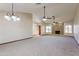 Open living room with a stone fireplace and vaulted ceilings at 14237 N Westminster Pl, Fountain Hills, AZ 85268