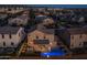 Two-story home with pool, lit up at night at 18402 N 65Th Pl, Phoenix, AZ 85054