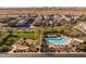 Aerial view of community pool, playground, and neighborhood homes at 18402 N 65Th Pl, Phoenix, AZ 85054