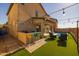 Outdoor kitchen and bar area with string lights and turf at 18402 N 65Th Pl, Phoenix, AZ 85054