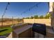Outdoor kitchen and patio area with string lights and seating at 18402 N 65Th Pl, Phoenix, AZ 85054