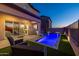 Inviting backyard oasis with a sparkling pool, lush landscaping, and patio seating at 18402 N 65Th Pl, Phoenix, AZ 85054