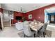Bright dining area with a large table, grey chairs, and view to living room and entryway at 18402 N 65Th Pl, Phoenix, AZ 85054